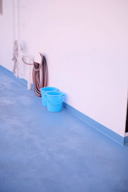 A person in protective gear disinfects a wall lamp to help prevent the spread of viruses.